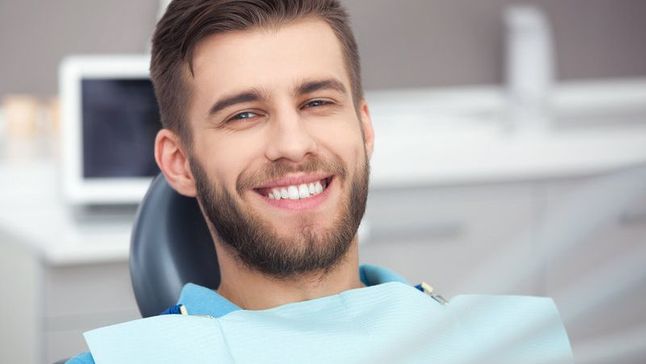 A man sitting in a dentist chair